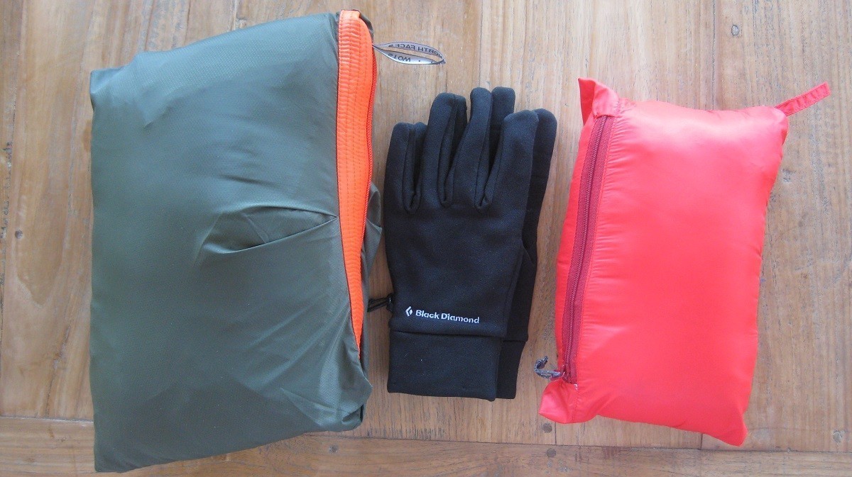 From left to right: Packed Low Pro Hybrid Jacket, for reference a pair of size M Black Diamond Lightweight Liner Gloves, Packed Broad Peak II